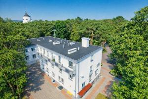 an overhead view of a white building with a tower at Ośrodek TVP in Ciechocinek