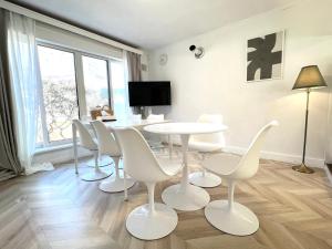 a dining room with a white table and chairs at Local Stay Hakodate in Hakodate