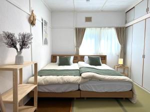 a bedroom with a bed and a window at Local Stay Hakodate in Hakodate