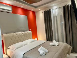 a bedroom with a bed with two towels on it at Aggelos Room 2 in Volos