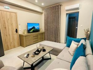 a living room with a couch and a tv at Aggelos Room 2 in Volos