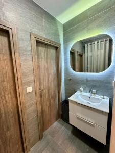 a bathroom with a sink and a mirror at Aggelos Room 2 in Volos
