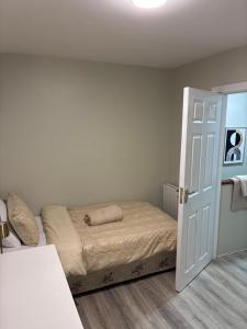 a small bedroom with a bed and an open door at Deelview in Eas Géitine