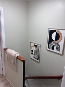 two pictures on a white wall with a towel at Deelview in Eas Géitine