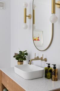 a bathroom with a white sink and a mirror at St Agnes by Prunella in Kyneton