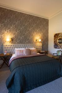 a bedroom with a large bed with pink pillows at St Agnes by Prunella in Kyneton