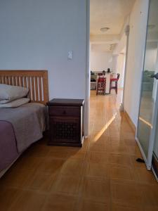 a bedroom with a bed and a wooden floor at Casa Sol-Oasis del Mar in Progreso +15 photos