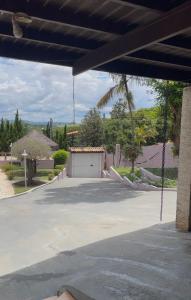 a parking lot with a garage and a swing at Chateau Magalhães in Itatiba