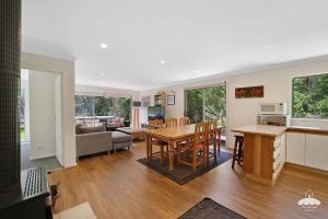 a kitchen and living room with a table and chairs at The Ash, Sandy Point Stay 3 Pay 2 Winter Special in Sandy Point