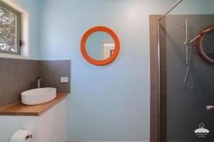 a bathroom with a sink and a shower with a mirror at The Ash, Sandy Point Stay 3 Pay 2 Winter Special in Sandy Point
