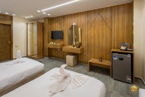 a hotel room with two beds and a television at Solis Pyramids View Hotel in Cairo