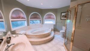 a large bathroom with a tub and a shower at Cornerstone Bed and Breakfast in Revelstoke +39 photos