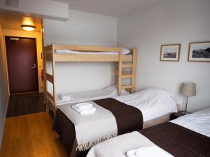 two beds in a room with two bunk beds at Hotel Korpoström in Korpoström +14 photos