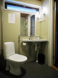 a bathroom with a toilet and a sink at Hotel Korpoström in Korpoström