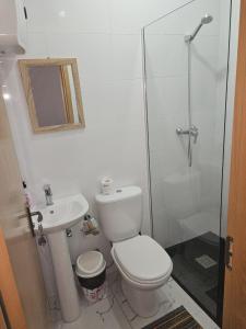 a bathroom with a toilet and a sink and a shower at Casa do Céu Azul in Tarrafal +16 photos