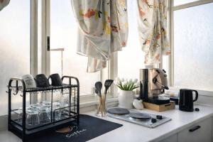 a kitchen counter with a stove and a window at Maison Geraldine in Marcianise