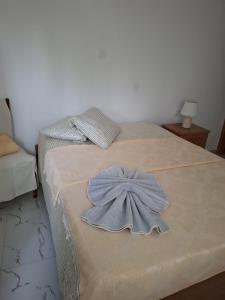 a bed with a blue dress on top of it at Casa do Céu Azul in Tarrafal
