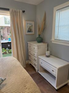 a bedroom with a bed and a dresser and a window at Eastside Costa Mesa Residence in Costa Mesa