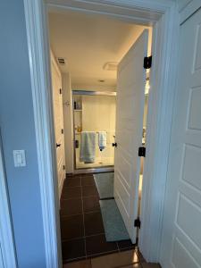 a bathroom with a walk in shower next to a door at Eastside Costa Mesa Residence in Costa Mesa +9 photos