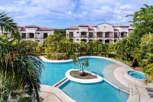 an aerial view of a resort with a swimming pool at Palmas de Tamarindo Resort, 304E in Guanacaste