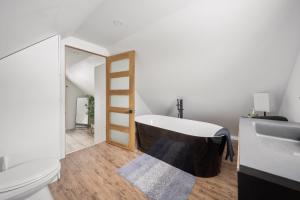 a bathroom with a bath tub and a sink at Évadez-vous à Grandes-Piles in Grandes-Piles +37 photos