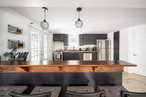 a kitchen with a large wooden table and chairs at Évadez-vous à Grandes-Piles in Grandes-Piles