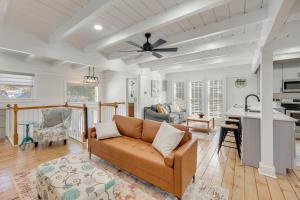 a living room with a couch and a ceiling fan at Beach Access & Fire Pit! Potomac River Retreat in Montross