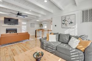 a living room with a couch and a tv at Beach Access & Fire Pit! Potomac River Retreat in Montross
