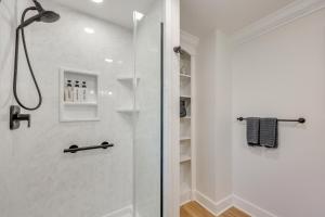 a shower with a glass door in a bathroom at Beach Access & Fire Pit! Potomac River Retreat in Montross +22 photos