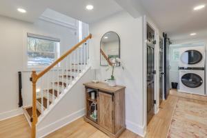 a hallway with a staircase and a mirror at Beach Access & Fire Pit! Potomac River Retreat in Montross