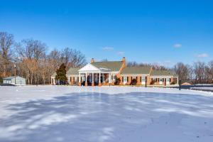 a house with a large ice rink in front of it at Beach Access & Fire Pit! Potomac River Retreat in Montross