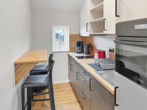 a kitchen with a counter and a stove top oven at City Pension Heide in Heide