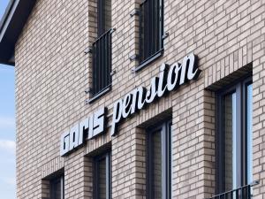 a sign on the side of a brick building at City Pension Heide in Heide +5 photos