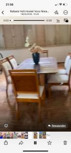 a screenshot of a picture of a table and a chair at MGerais Hostel e Empório in Visconde do Rio Branco +5 photos