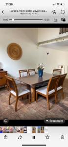 a picture of a table and chairs in a room at MGerais Hostel e Empório in Visconde do Rio Branco