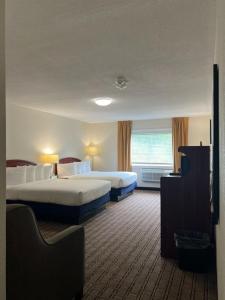a hotel room with two beds and a window at River Valley Inn in Hatfield