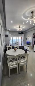 a living room with a table and a couch at Βeachfront Luxury Apartments SARANDE in Sarandë