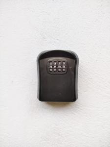 a black object is attached to a white wall at Nosara Hideaway 1 - Mountain View Cabins & BREAKFAST AVAILABLE in Naranjal
