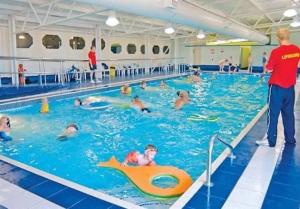 a group of people swimming in a swimming pool at Sandy Bay- No38 The Waterfront in North Seaton