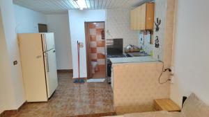 a kitchen with a refrigerator and a counter top at بيت الحجر 2 in Amman