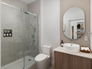 a bathroom with a shower and a toilet and a sink at Chalet Symbiose21 - Vue montagne, Sauna et spa in Saint Come +31 photos