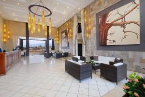 a lobby with couches and a painting on the wall at Protea Hotel by Marriott Chipata in Chipata +57 photos