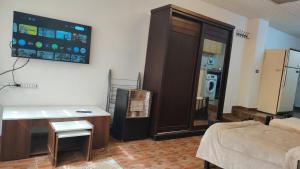 a living room with a room with a television and a couch at بيت الحجر 2 in Amman