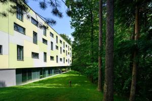 an external view of a building with trees at Four Points by Sheraton Ljubljana Mons in Ljubljana