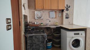 a small kitchen with a sink and a washing machine at بيت الحجر 2 in Amman +10 photos