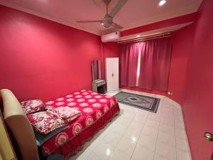 a red room with a bed and a red wall at Teratak Embah in Nilai