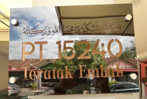 a sign in the window of a restaurant with a sign for a dealership at Teratak Embah in Nilai