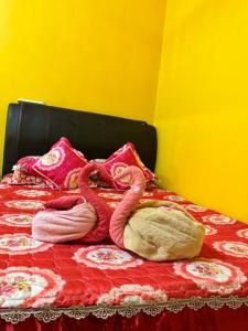 a bed with two pink towels on top of it at Teratak Embah in Nilai +8 photos
