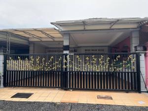 a black gate in front of a house at Teratak Embah in Nilai