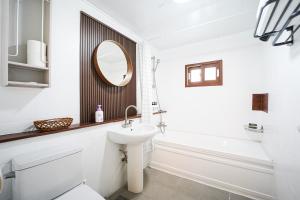 a bathroom with a sink and a toilet and a mirror at Traditional Korean houses Stay Yeon in Busan +30 photos